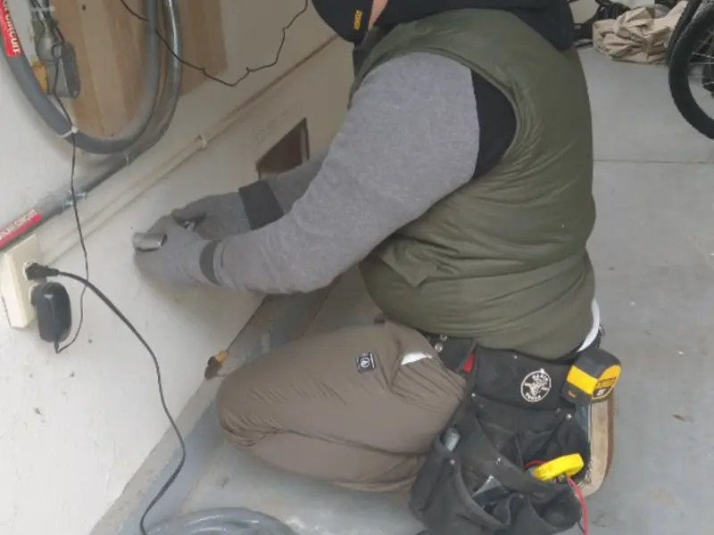 Electrician performing outlet wiring in a Port Angeles East garage